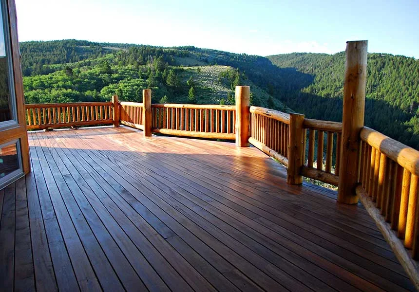 A log-railed deck overlooking a timbered canyon in the Big Hole foothills
