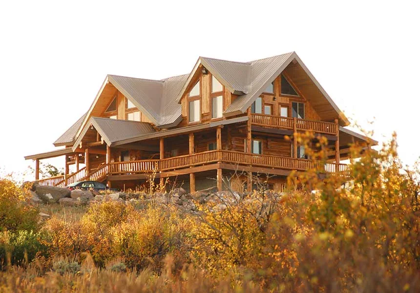 The ranch lodge in golden evening light above the sagebrush